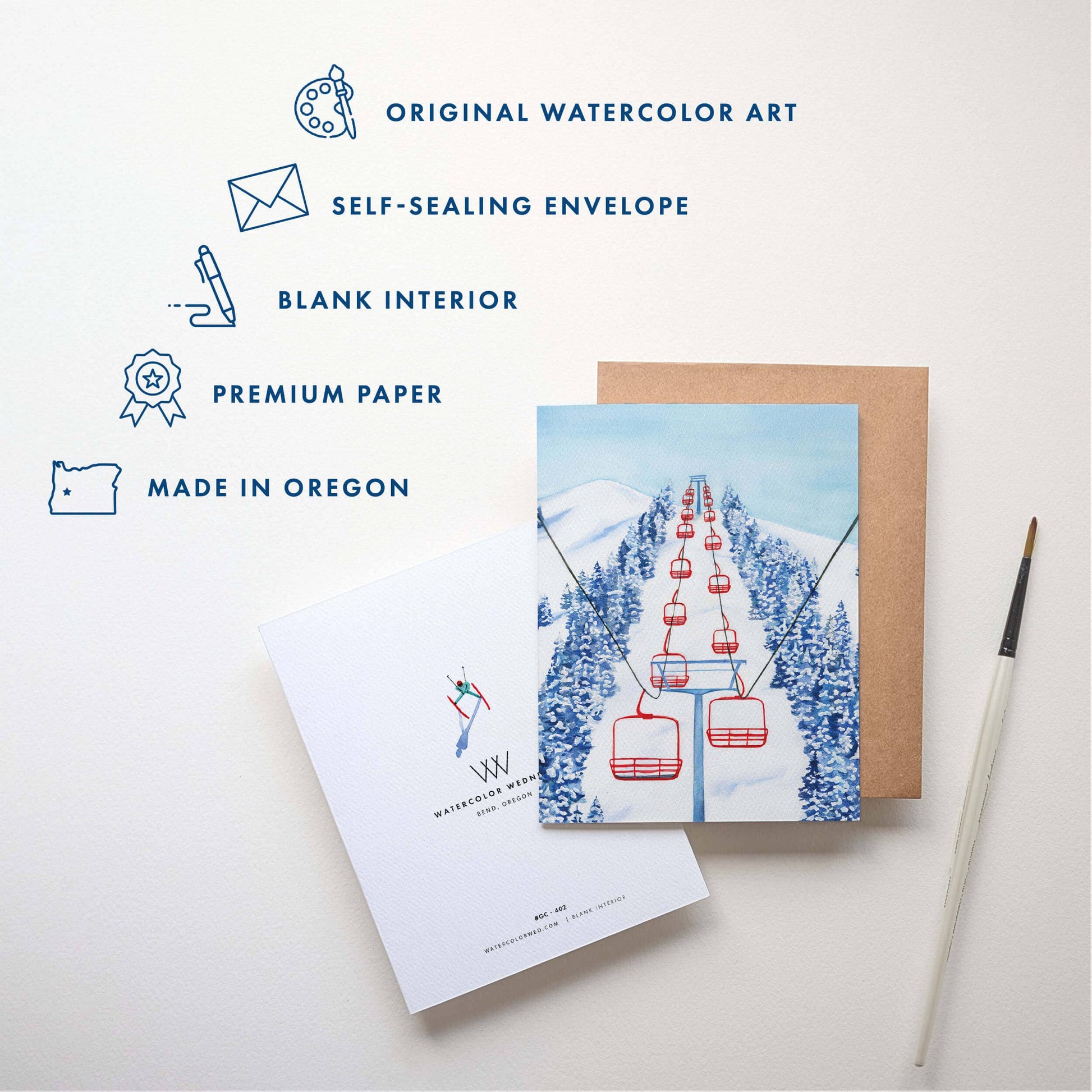 Greeting card with ski lift illustration, envelope, and stationery items on a light background