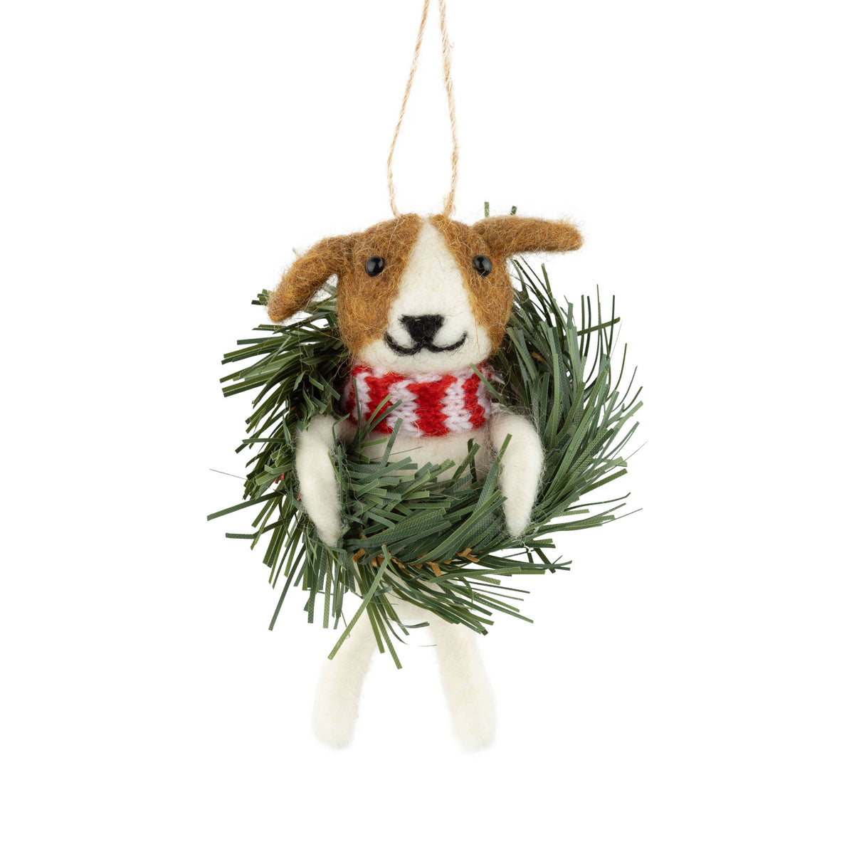 A felt dog Christmas ornament with brown and white fur, wearing a red and white striped scarf and sitting inside a green pine wreath, hanging from a natural jute string against a white background.