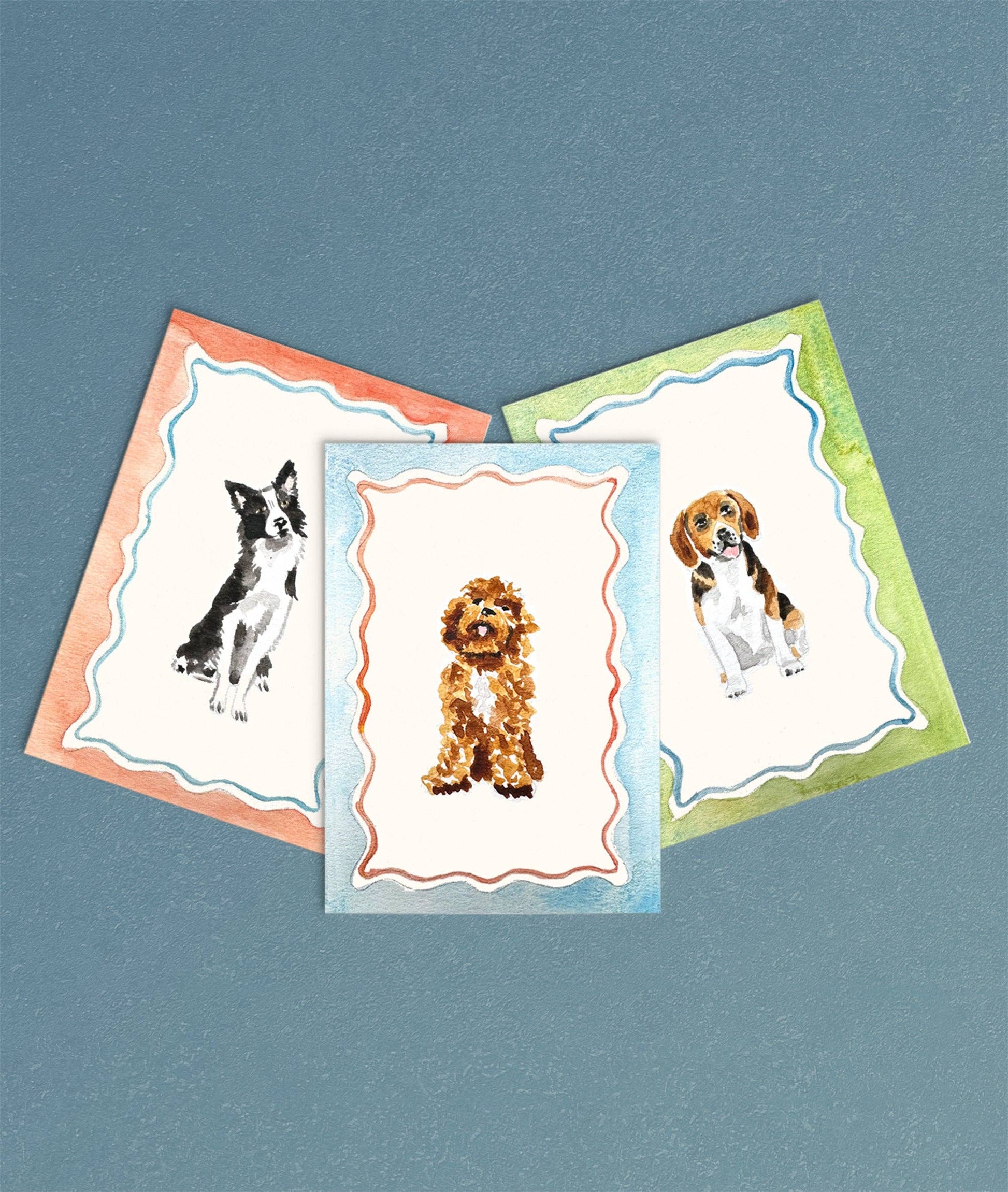 Three greeting cards with dog illustrations on a blue background