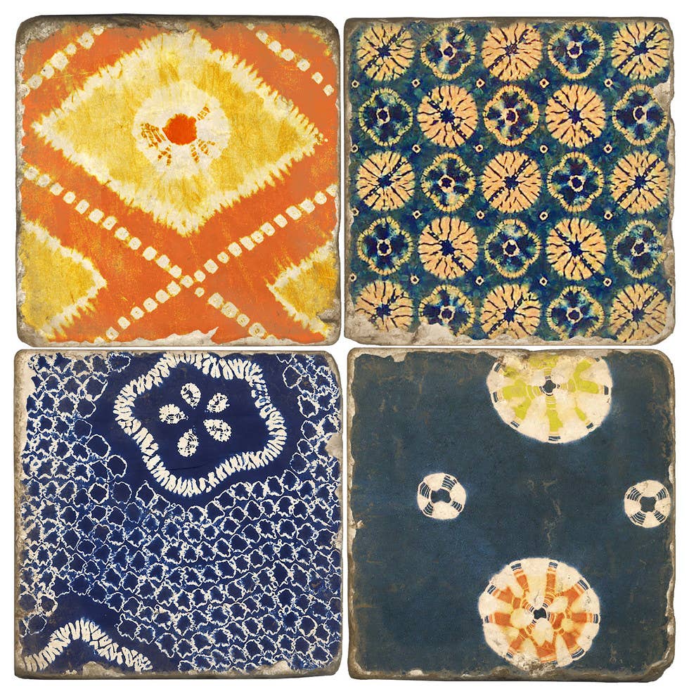 Four square ceramic tiles arranged in a 2x2 grid, each featuring a distinct hand-painted geometric and floral pattern in earthy tones of orange, yellow, blue, and cream.
