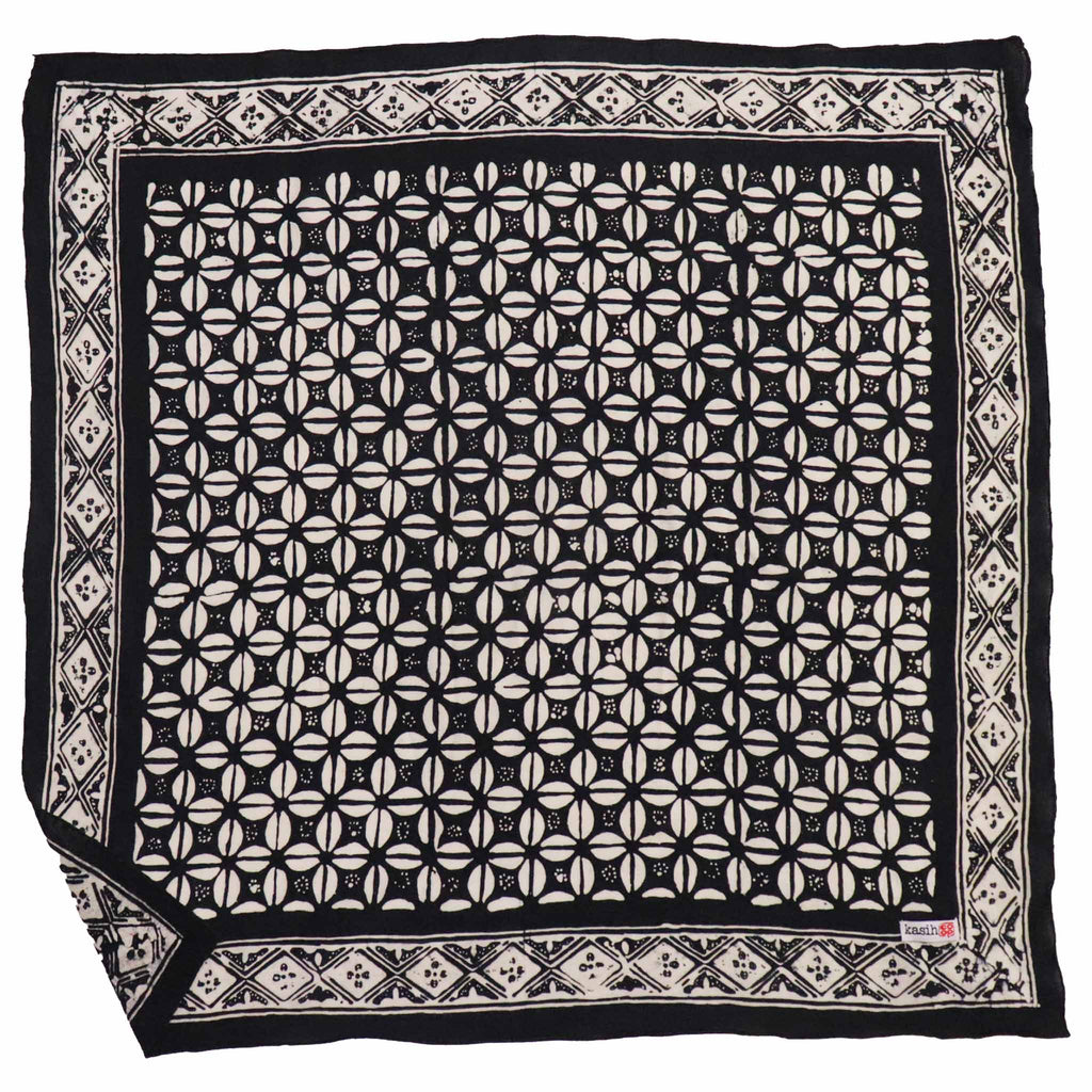 Black and white patterned fabric square with brand label in the corner