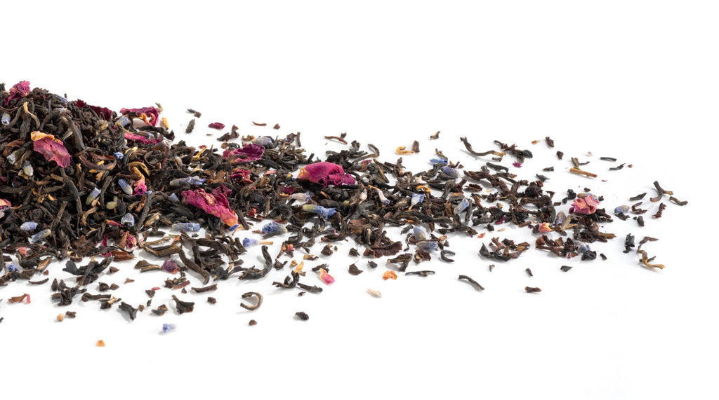 Assorted dried tea leaves on a white background