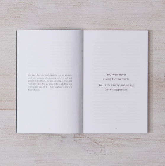 Open book with text on a wooden surface