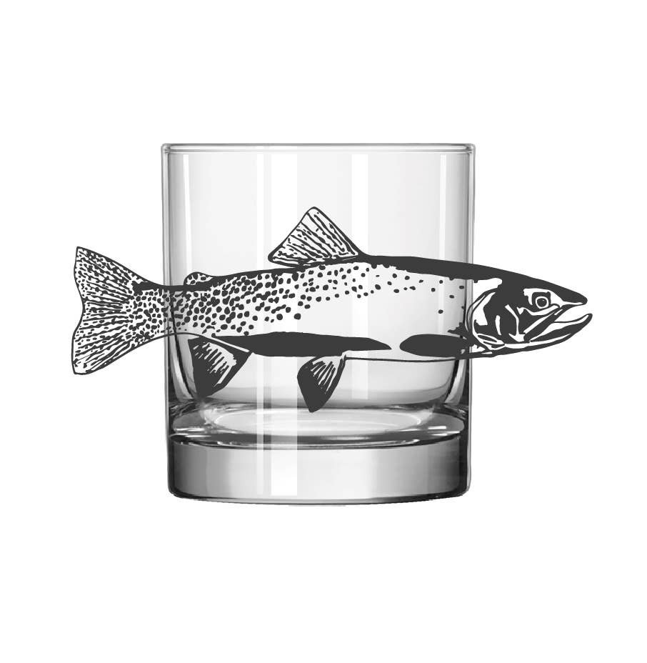 A clear glass rocks tumbler with a black fish silhouette printed across the side, shown on a plain white background.