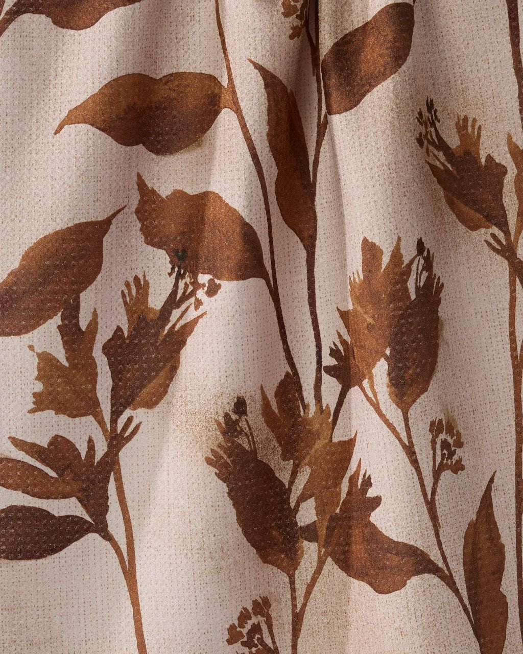 Close-up of brown floral pattern on beige fabric