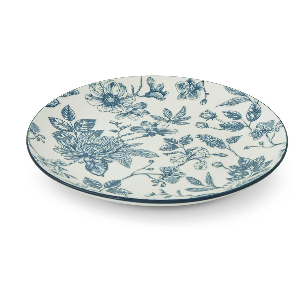 An oval ceramic plate with a blue floral toile pattern on a white background, photographed from a high angle on a clean white studio background.