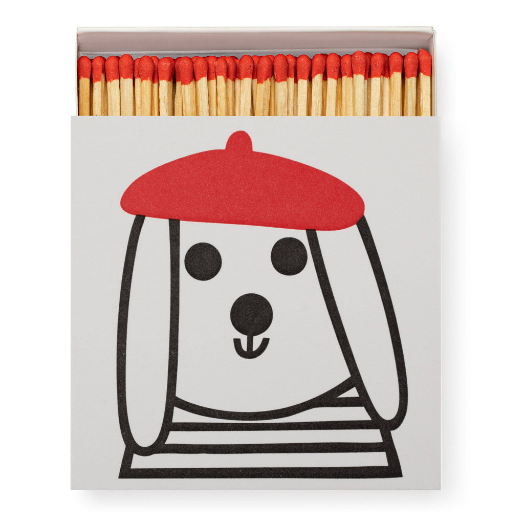 Matches with a dog illustration wearing a red beret on a white background