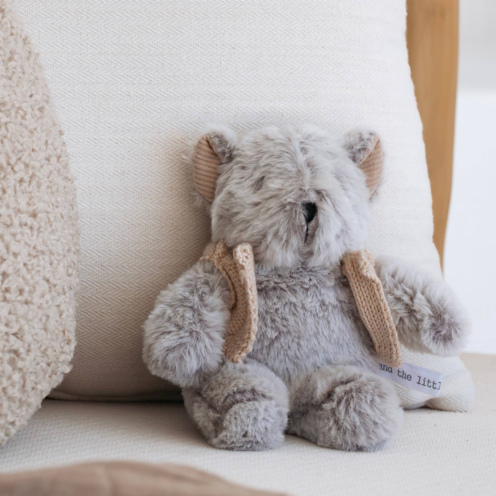 Plush elephant toy with knitted ears on a soft surface