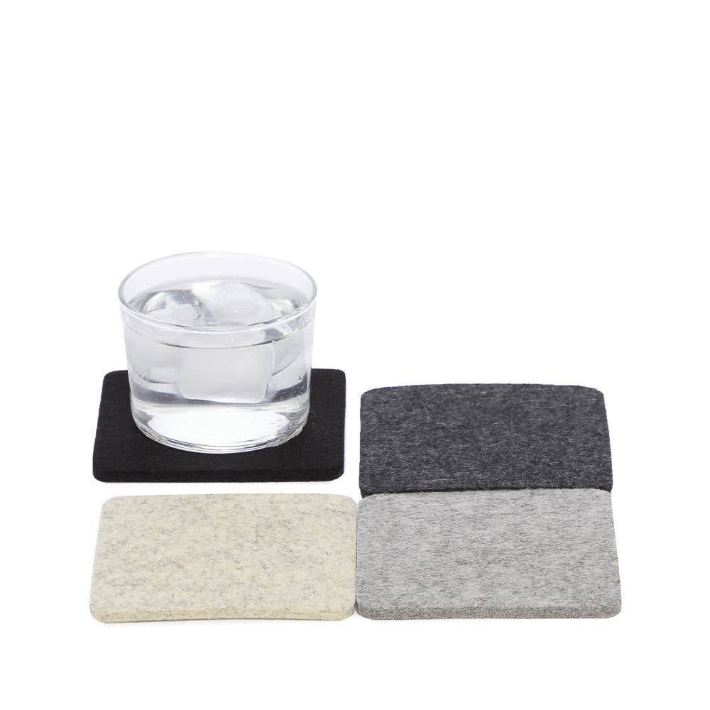 Set of coasters with a glass of water on a white background