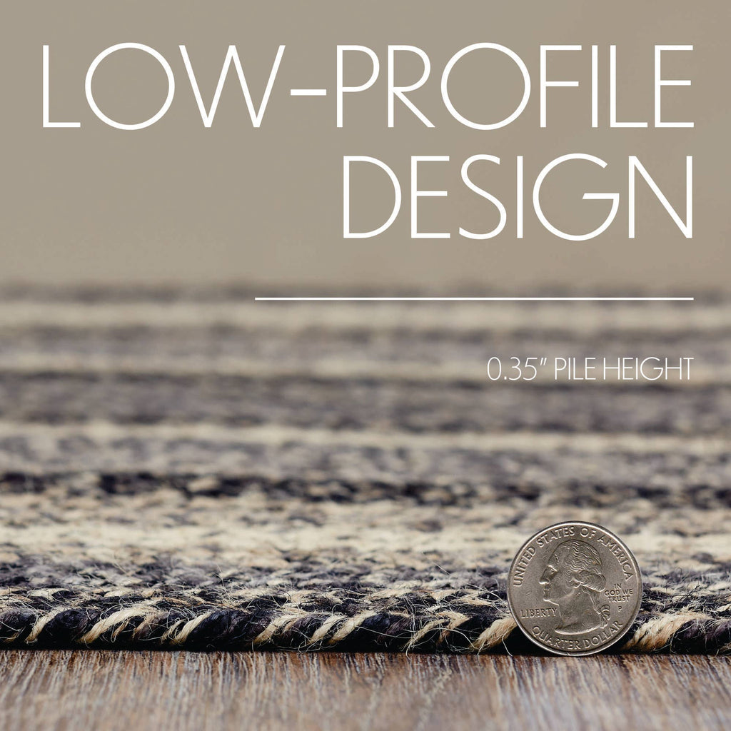 A close-up of a low-pile area rug with a textured, heathered pattern in beige, brown, and black, shown on a wooden floor with a coin for scale and text overlays reading 'LOW-PROFILE DESIGN' and '0.35" PILE HEIGHT'.