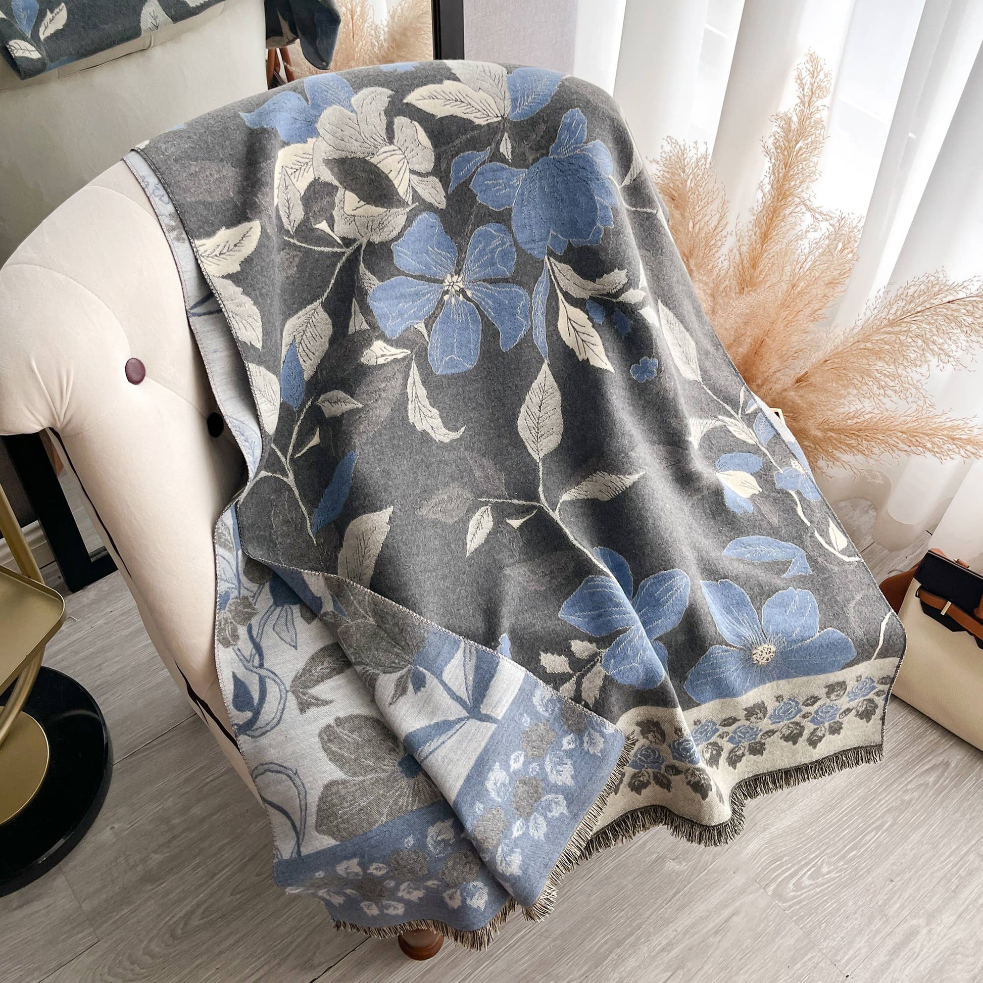 Floral patterned blanket draped over a chair in a home setting