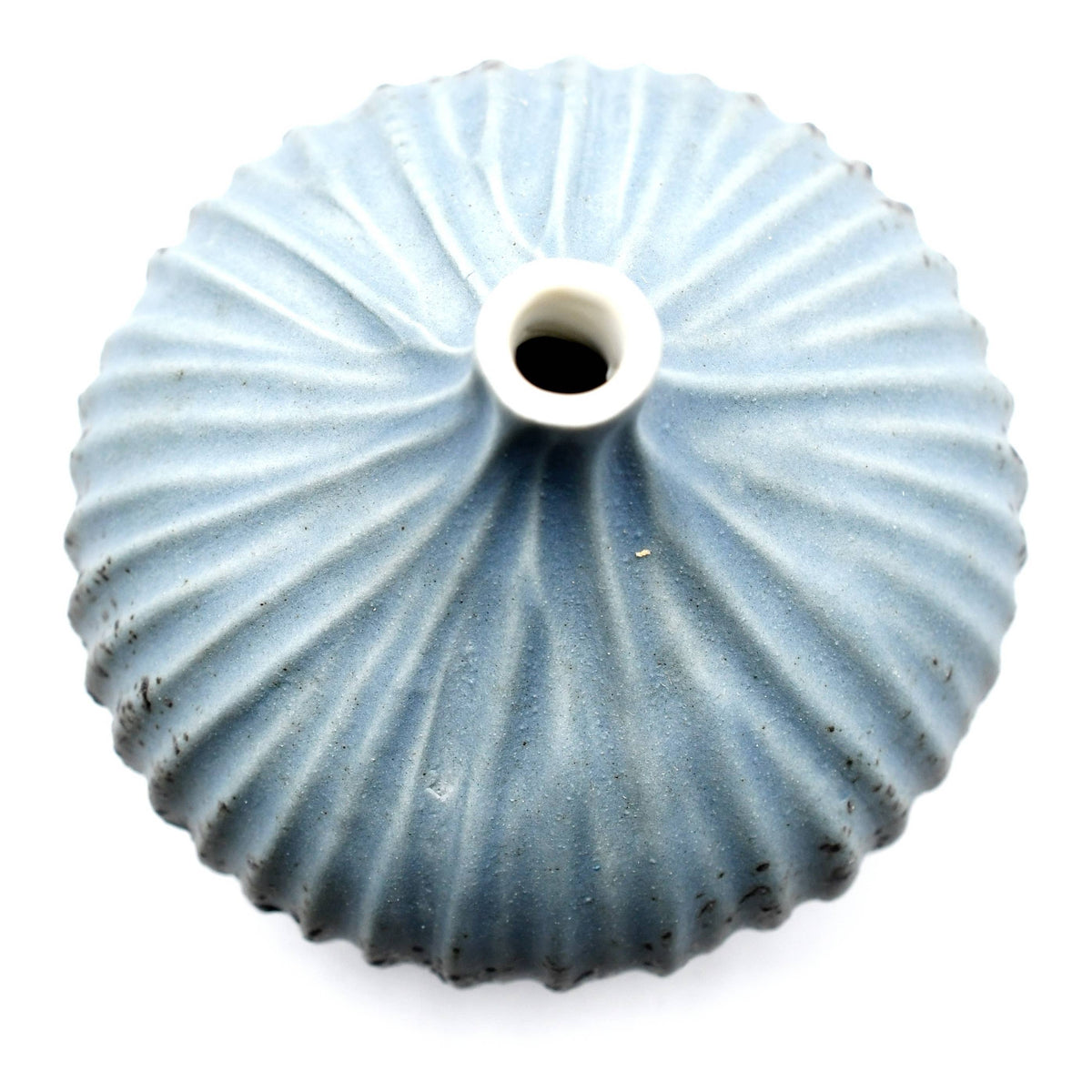 A light blue ribbed ceramic vase with a central hole, shown from a top-down view on a white background.