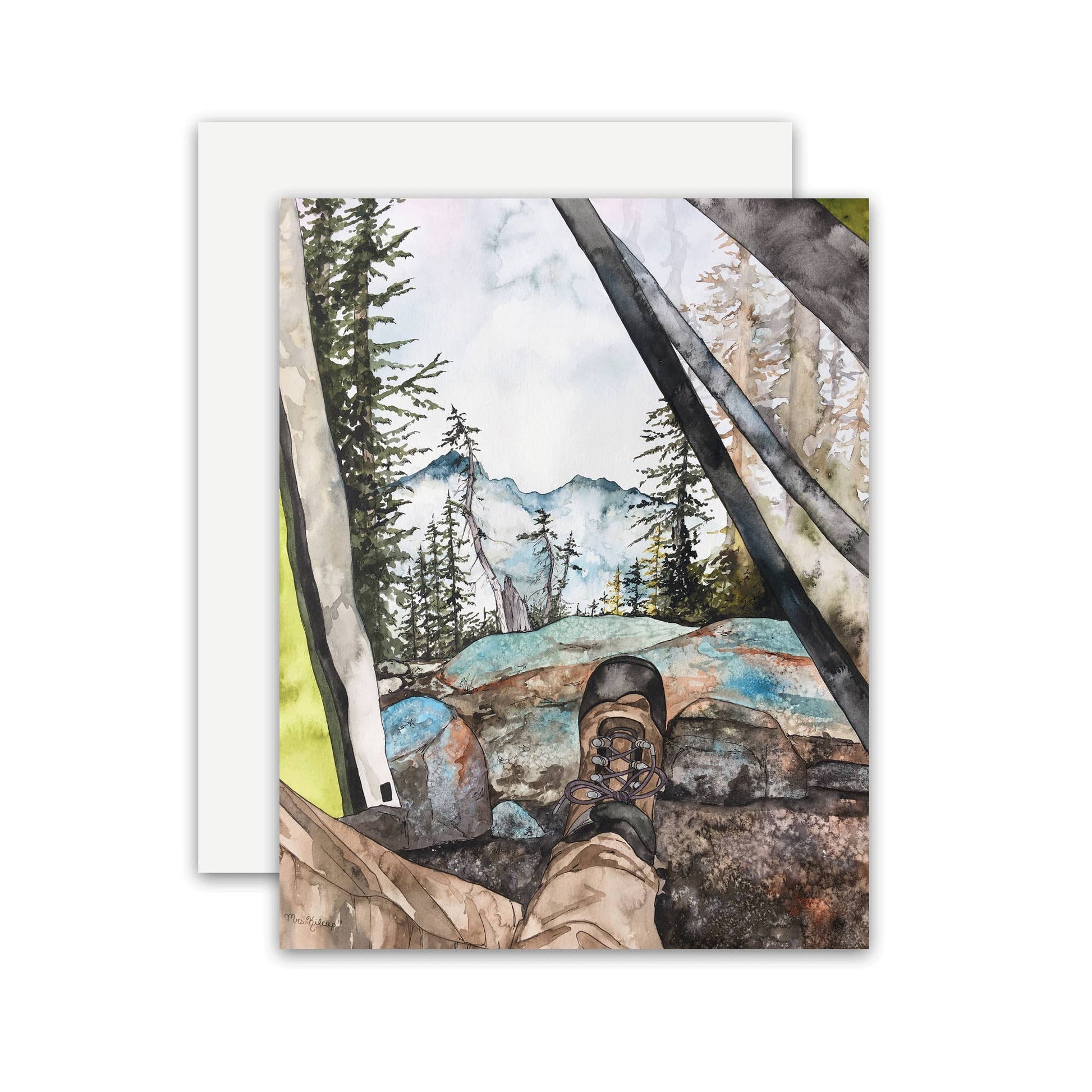 A square art print or card featuring a watercolor-style outdoor scene with mountains, pine trees, rocks, and a hiking boot in the foreground, shown with a white envelope behind it on a light gray background.
