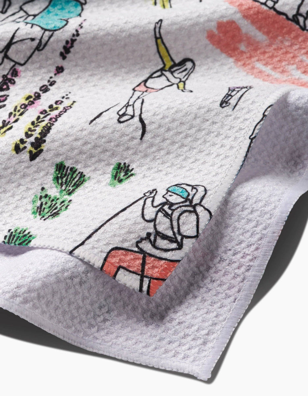 A multicolored tea towel with a character-based pattern design.